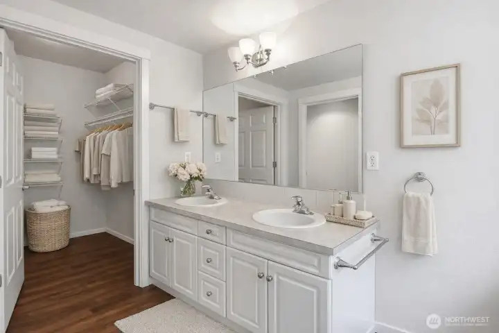 Primary bath has a double vanity and large walk-in closet.  This photo has been virtually staged.