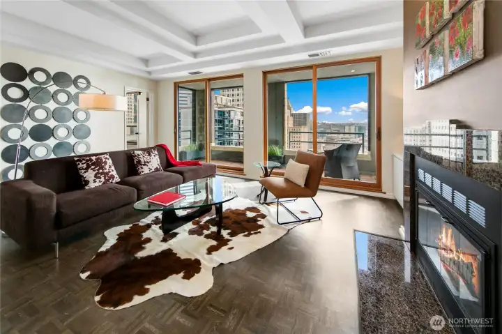 The penthouse living room supports both intimate gatherings and larger evenings of conversation, the skyline always present beyond the glass.