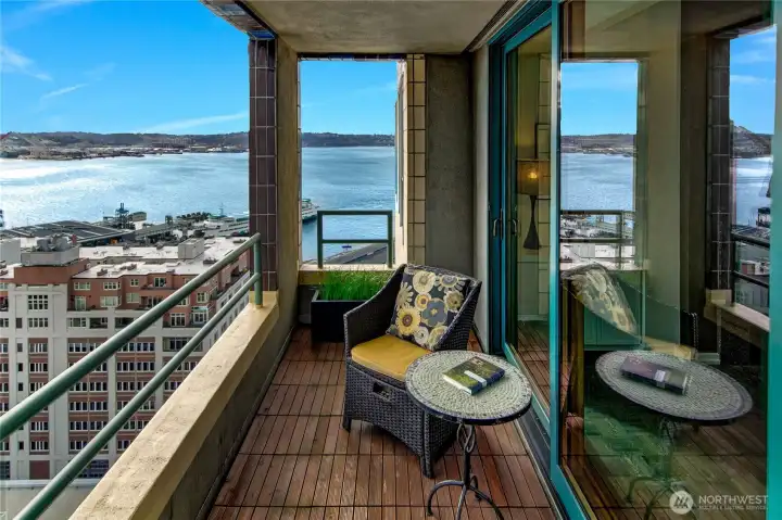 One of two covered terraces extends the penthouse living spaces outward, offering sheltered seating above the harbor and waterfront.