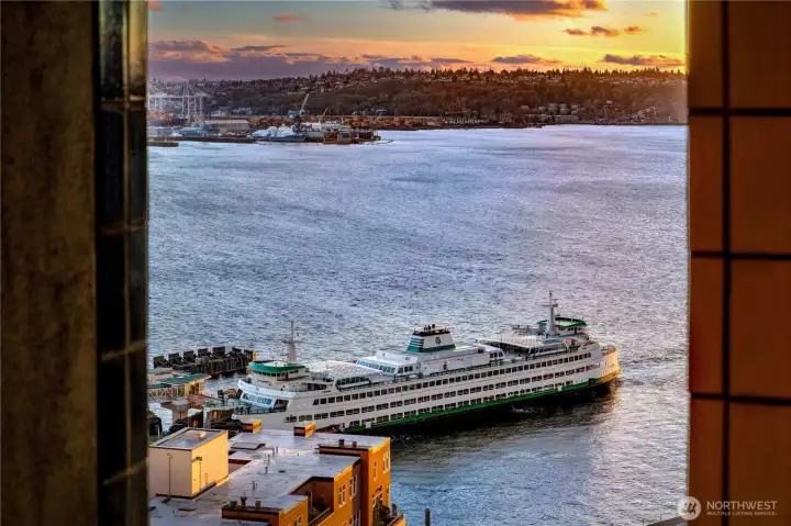 From the penthouse terrace, the working harbor animates the horizon as vessels move across Elliott Bay.