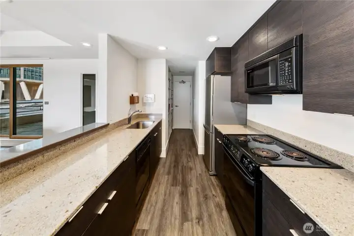 Clean lines and refined finishes support the kitchen’s role as both workspace and gathering point within the penthouse.
