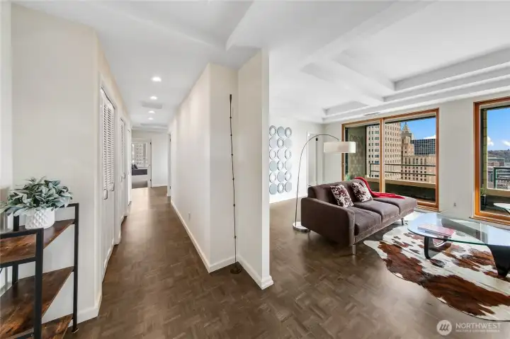 The gallery approach to the living room builds anticipation before the space opens to the penthouse’s southern panorama.