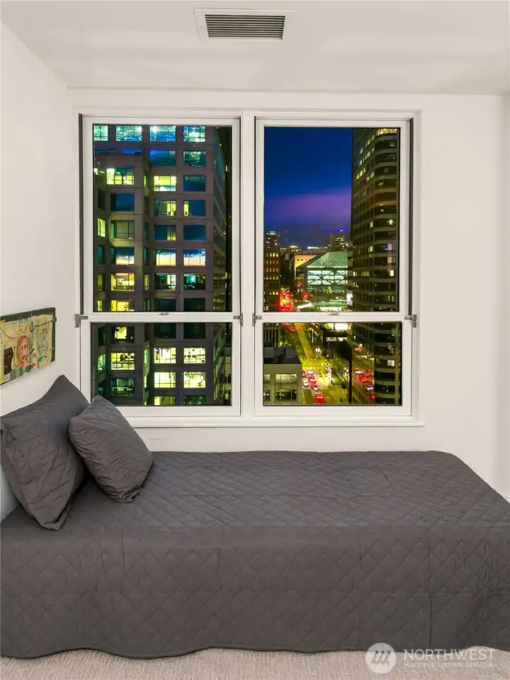 City lights lend a quiet presence to the room as evening settles across downtown.