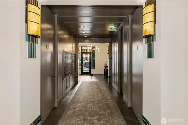 A quiet residential corridor leads to the upper levels where the penthouse is located.