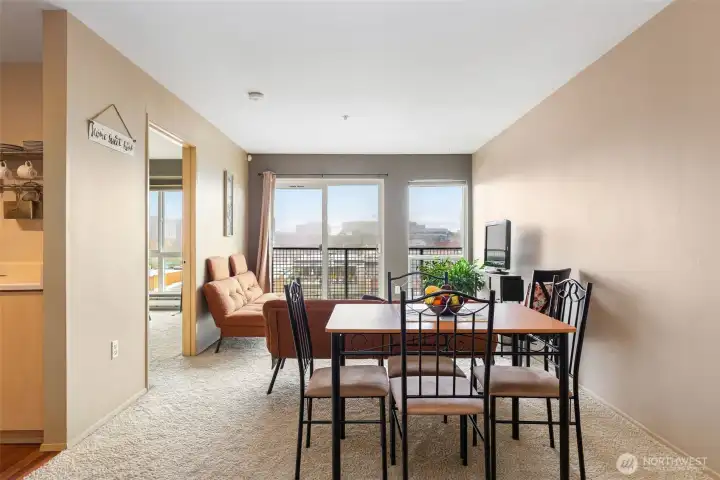 Open dining area with city views and access to bright living space