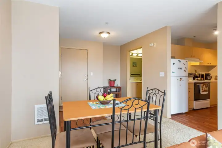 Dining area with view into kitchen featuring ample counter and storage space