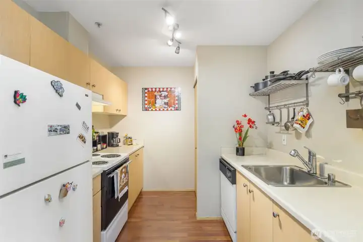 Well-equipped kitchen with stainless sink, ample counter space, and upper cabinets