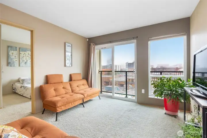 The living room flows into the bedroom with mountain and city views.