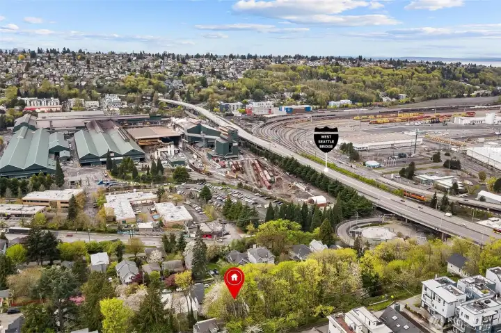 Aerial view showing proximity to West Seattle Bridge access, rail lines, and major transportation routes connecting to downtown Seattle.