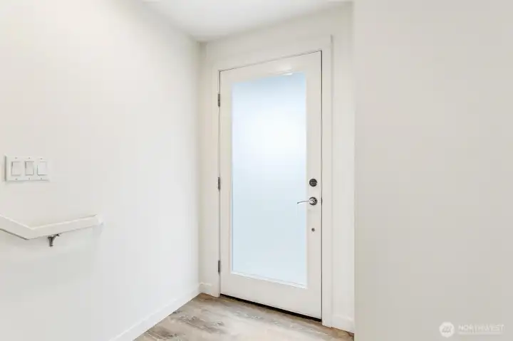Interior entry landing with clean finishes, stair access, and durable flooring.