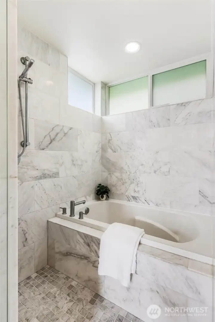 Walk-in shower and bath with modern finishes for a spa like experience.