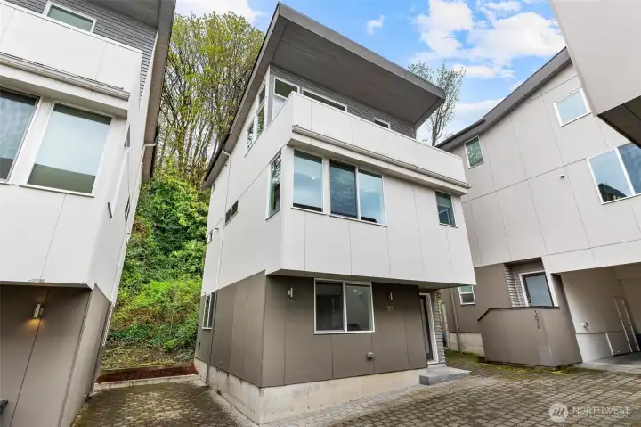 Front exterior of home showing multi-level design, modern siding, and elevated position.