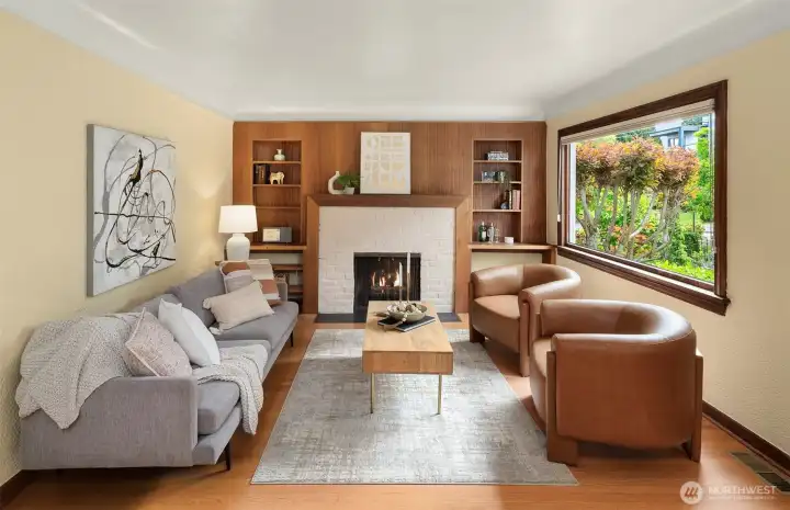 Living room features coved ceiling, hardwood floors, wood burning fireplace and built-in shelves.