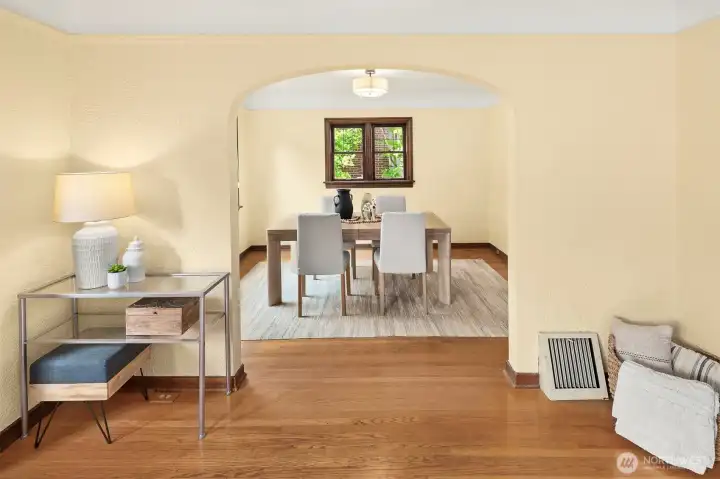Arched entry way separating dining and living rooms.