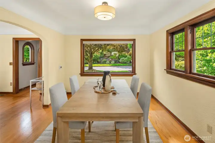 Dining room features coved ceiling and large windows.
