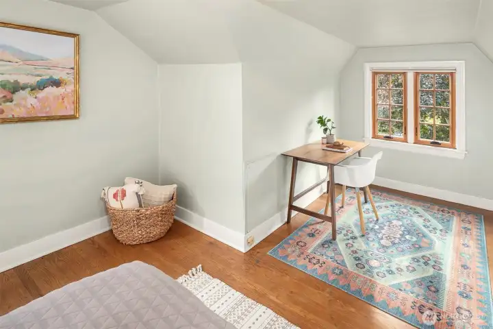 One of two upstairs bedrooms with space for desk or reading area.