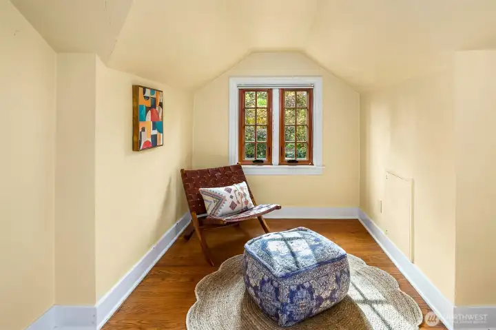 Second upstairs bedroom with reading area, desk, or play space.