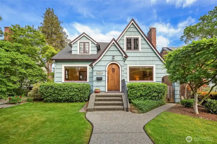 Wonderful house on tree-lined street packed featuring arched mahogany front door.