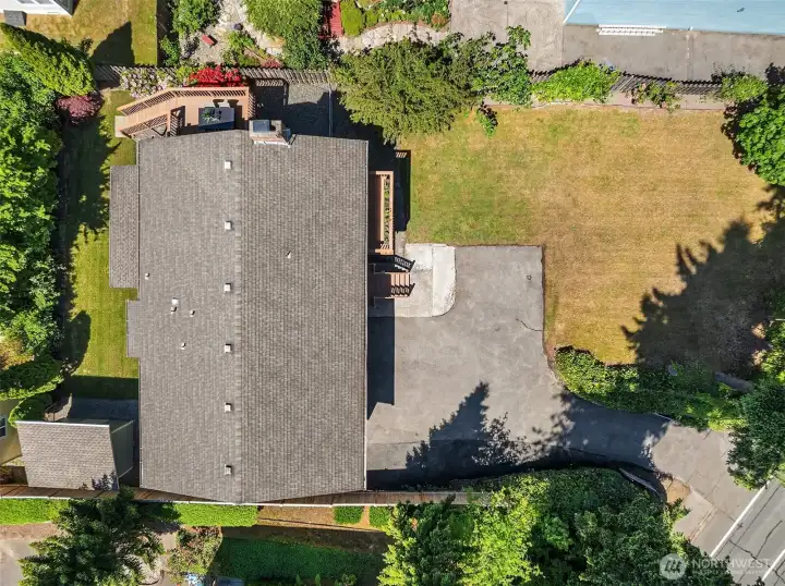 Sweeping private lot with new sod, mature trimmed trees and lots of parking.