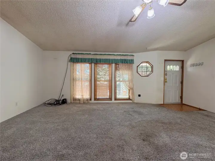 Floor to ceiling Living room windows, and front door entrance Floor to ceiling Living room windows, and front door entrance