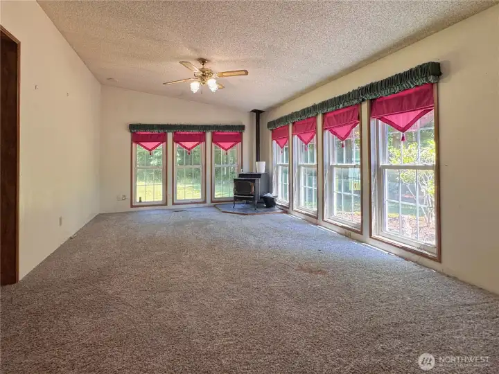 Family room with floor to ceiling windows and pellet stove Family room with floor to ceiling windows and pellet stove