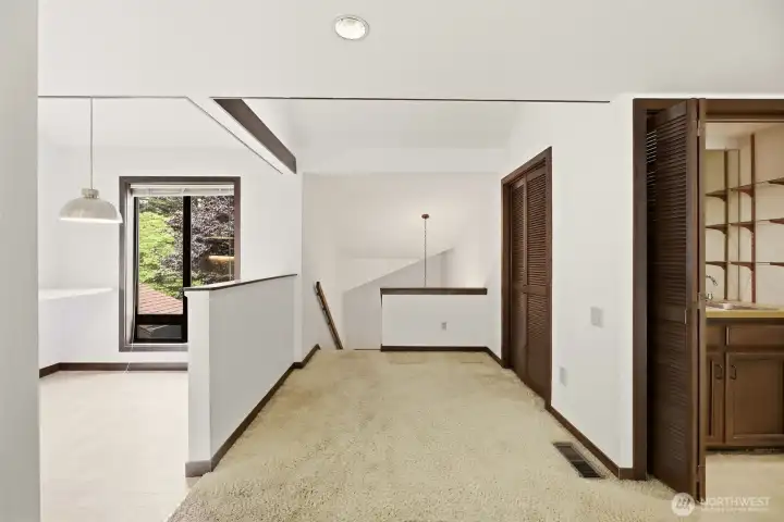 view of breakfast nook, entry stairs and wet bar