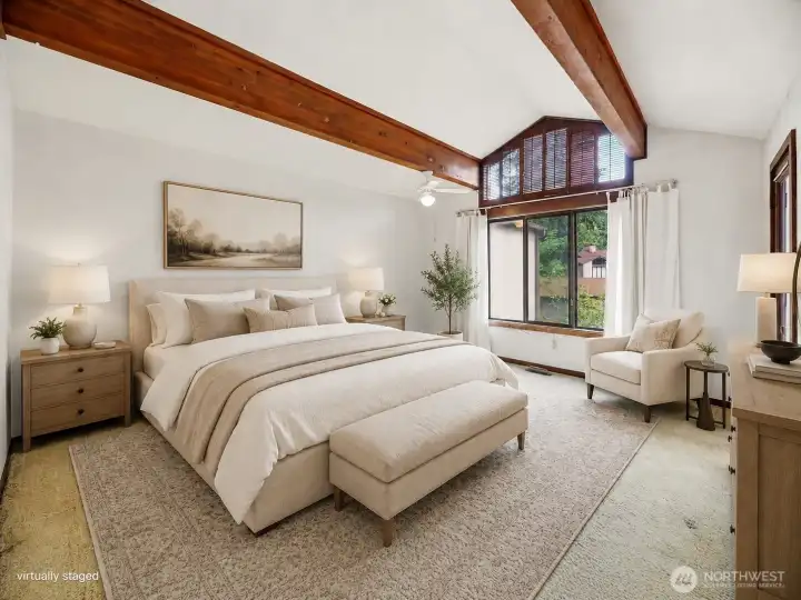 Primary suite- vaulted ceiling, light filled room with a door to the balcony