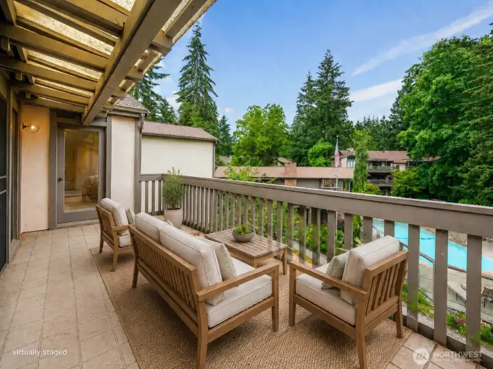balcony overlooking the pool and park like grounds