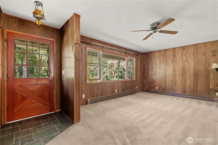 Slate flooring enhances the entry and living room with rustic charm.