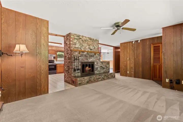 Spacious living room featuring a cozy wood-burning fireplace.