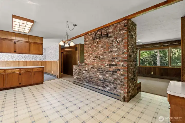 Brick chimney facing the kitchen adds character and showcases the home's original craftsmanship.