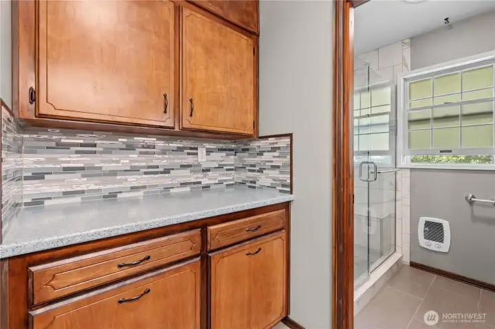 Modern hall bathroom showcases an oversized walk-in shower with attractive tile accents. One of the two 3/4 bathrooms.