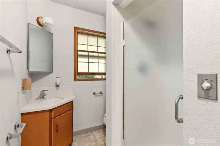 Convenient 3/4 bath just inside the garage entrance—ideal for scrubbing up after working in the barn, shop, or around the property.