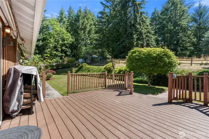 Newer composite deck offers low-maintenance outdoor living and includes a roll-out shade for added comfort. A new replacement shade is included and ready for installation.