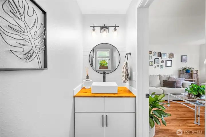 Updated half bath on main floor with tiled floors and vanity.