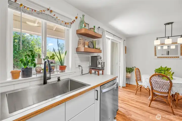 Light and bright kitchen with updated faucet/sink/hardware and appliances.