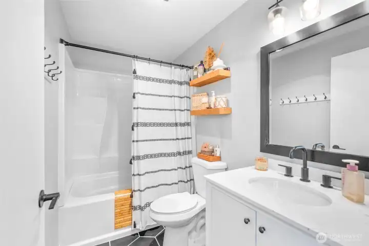 Updated Full bath upstairs w/tiled floor and new vanity.