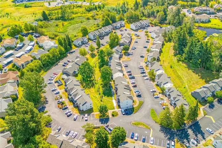 Great complex with tons of green space and lots of parking around this unit!