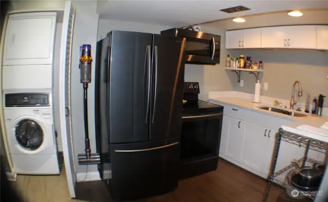 Kitchen in ADU.   Stacking washer & drier.