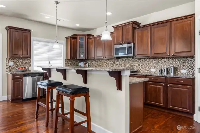 You will love entertaining in this kitchen with breakfast bar seating, granite counters and open sight lines to the living room and dining room.