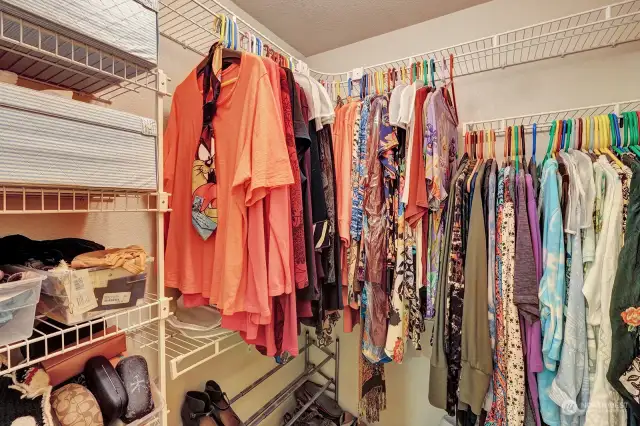 Large walk in closet in primary bedroom has built in shelving for your convenience.