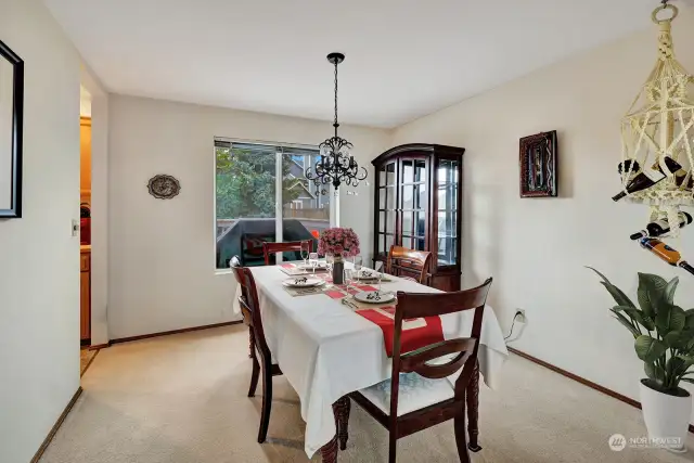 Formal dining room will easily accommodate 6 or more table seating and additional furniture. Steps to the kitchen area.