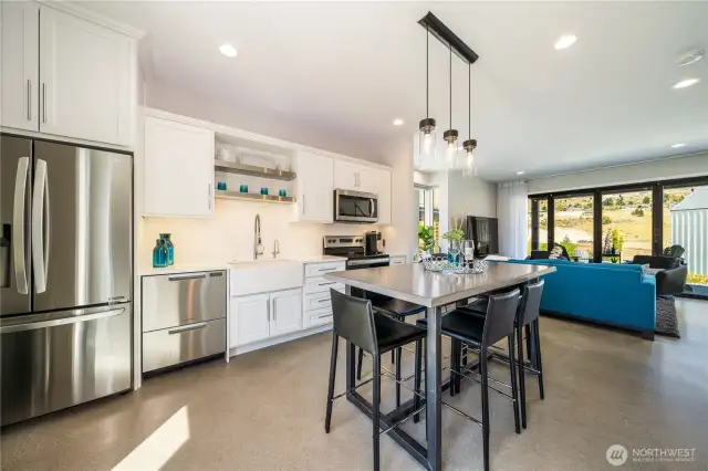 Concrete floors, stainless steel appliances, and a wide-open floor plan. Views from every window!