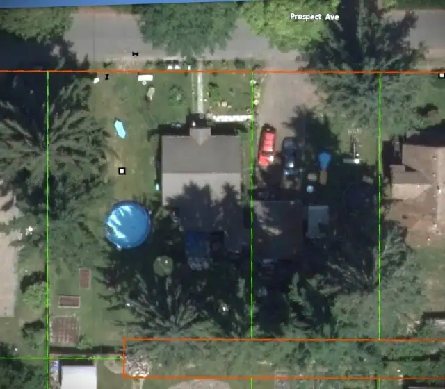 The subject vacant land includes the driveway, as pictured here. House and pool are on the original lot that is not for sale.