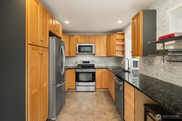 Enjoy soft-close cabinetry, tile flooring, a KitchenAid dishwasher and sink — plus a sunny windowbox perfect for herbs.