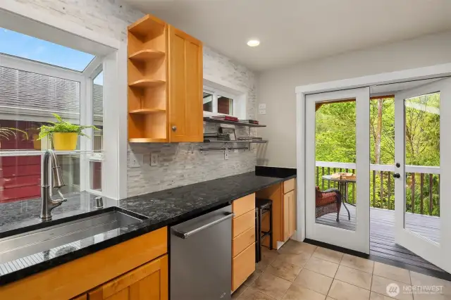 French doors flow from the kitchen to a spacious Trex deck, ideal for BBQs, lounging, or catching the sunset over the backyard.
