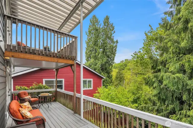 Relax in peace as you gaze westward toward your expansive backyard, framed by mature cedars above.