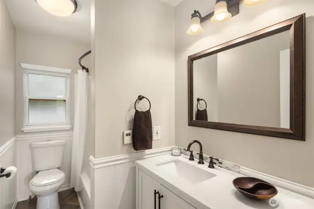 Primary suite bathroom featuring exquisite wainscoting.