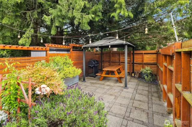 Relax on the private front patio, adorned with string lights — perfect for welcoming guests or grilling with the built-in Char-Griller gas setup.