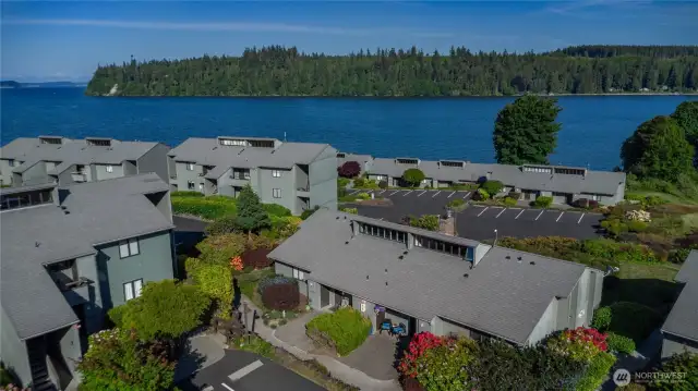Bulding #10, Unit #10 is the condo in the middle of the photo with the two blue chairs. The views are better in person. There's lots of parking, the clubhouse, marina, pickleball court, public beaches and restaurant are all right outside the door.
